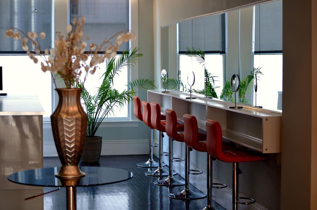 The styling bar at Maison Coupe: terracotta chairs, round mirrors and window light