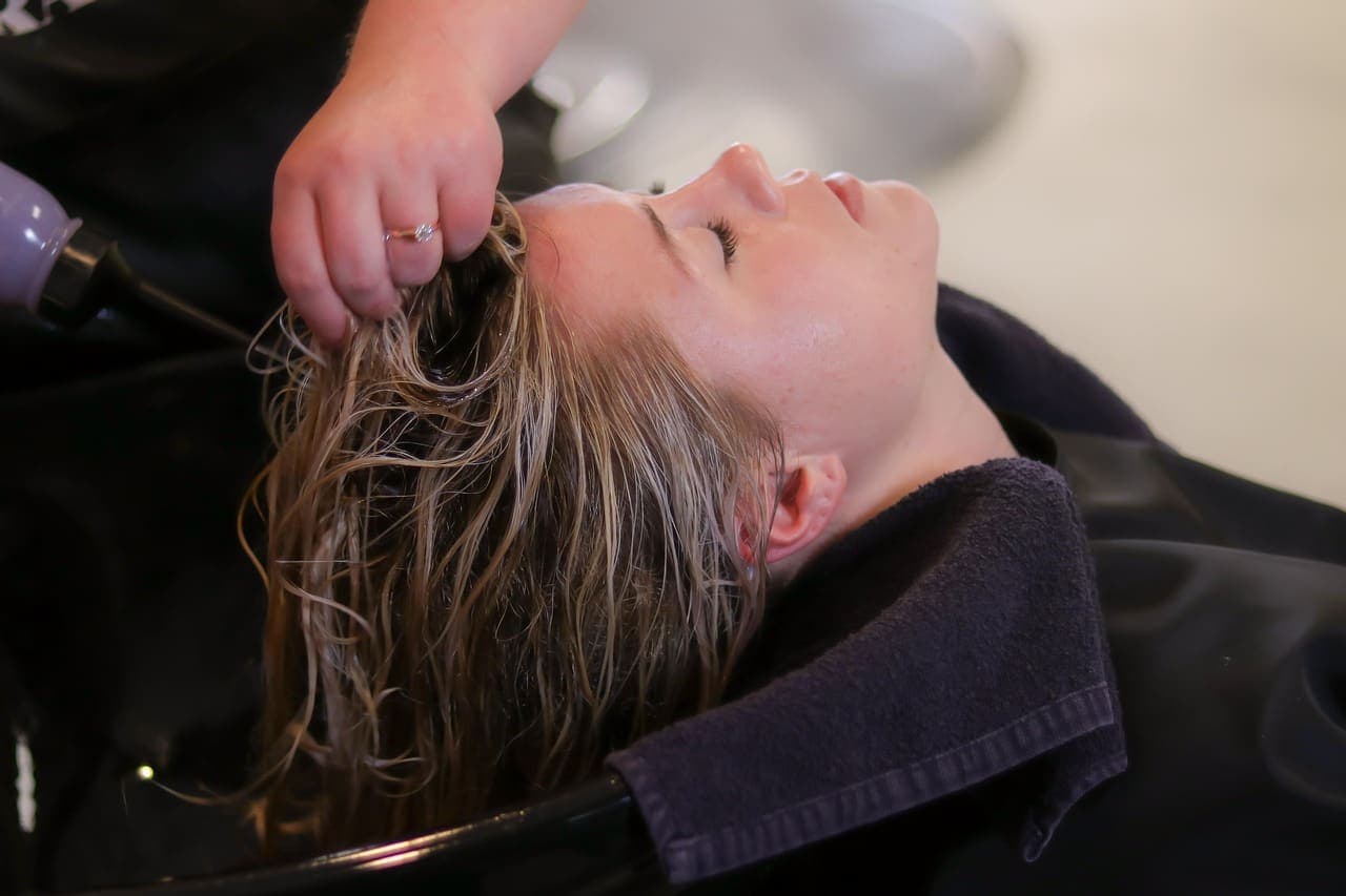 Guest reclined at the basin while her hair is rinsed