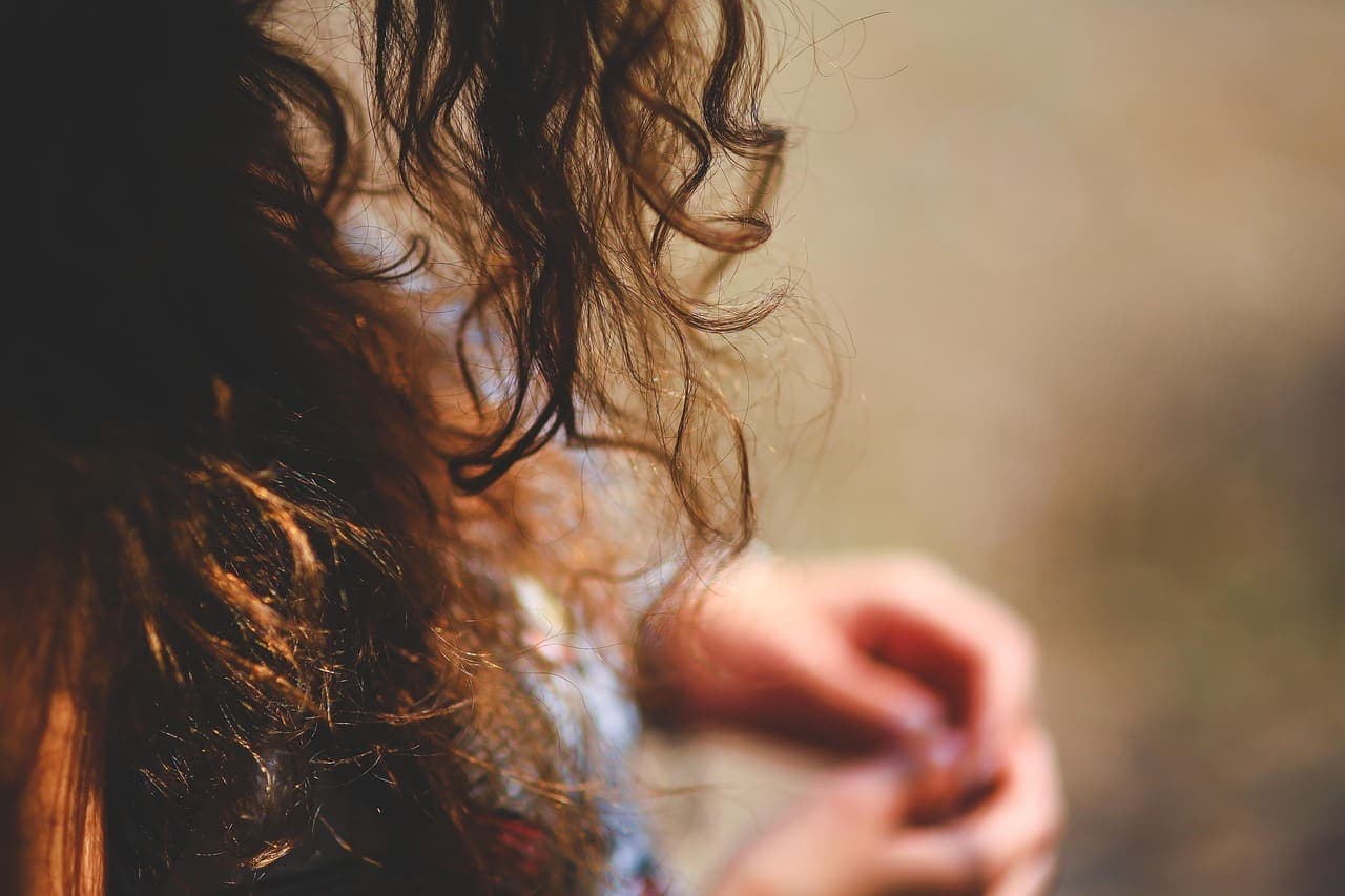 Close-up of glossy chestnut curls